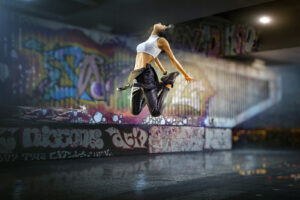 Female Hip Hop Dancer. Beautiful girl dancing at night on the background of graffiti wall